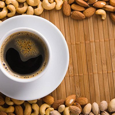 pngtree-coffee-with-nuts-on-background-health-addiction-espresso-photo-image_7027130